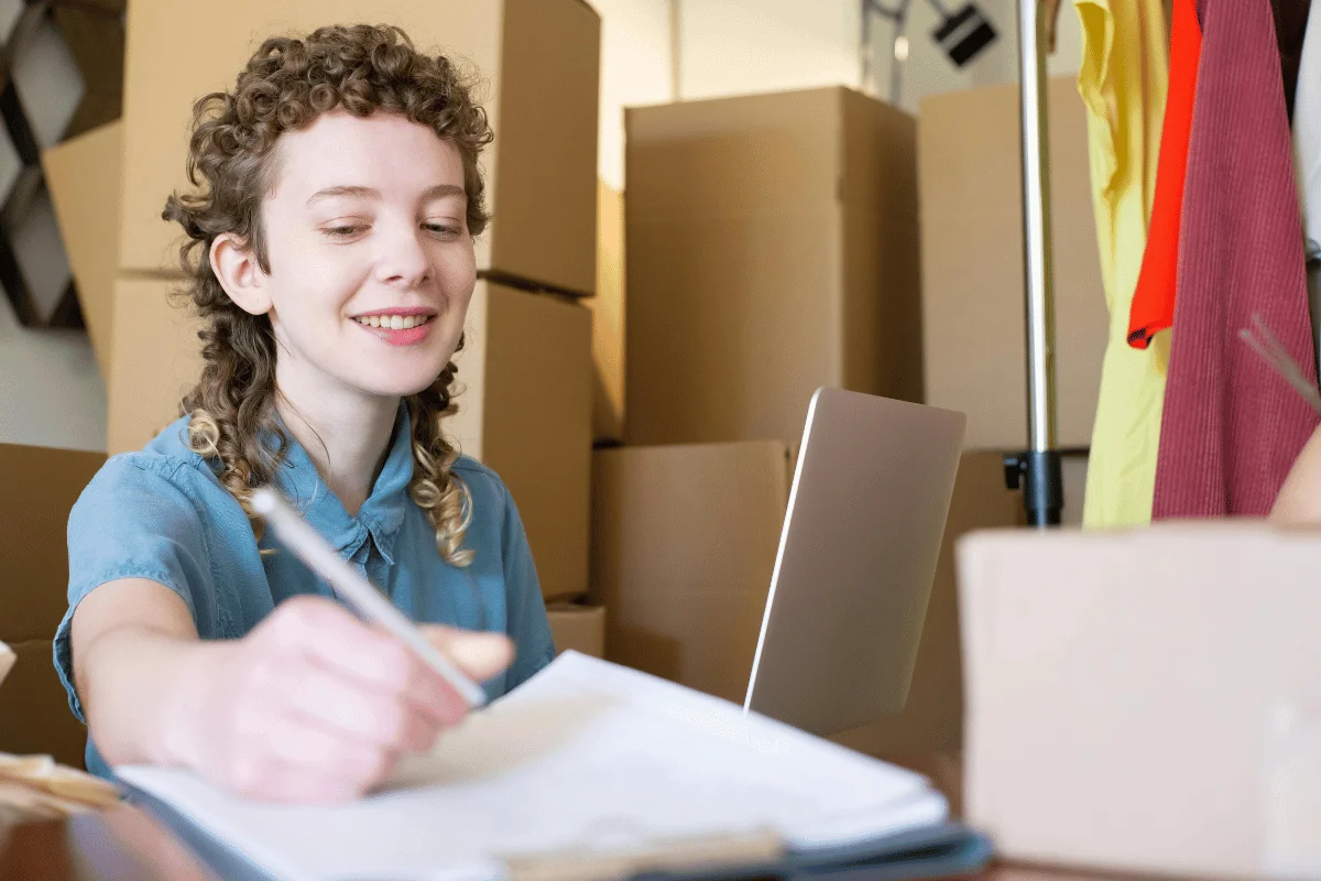 Cheerful business owner organizing orders.